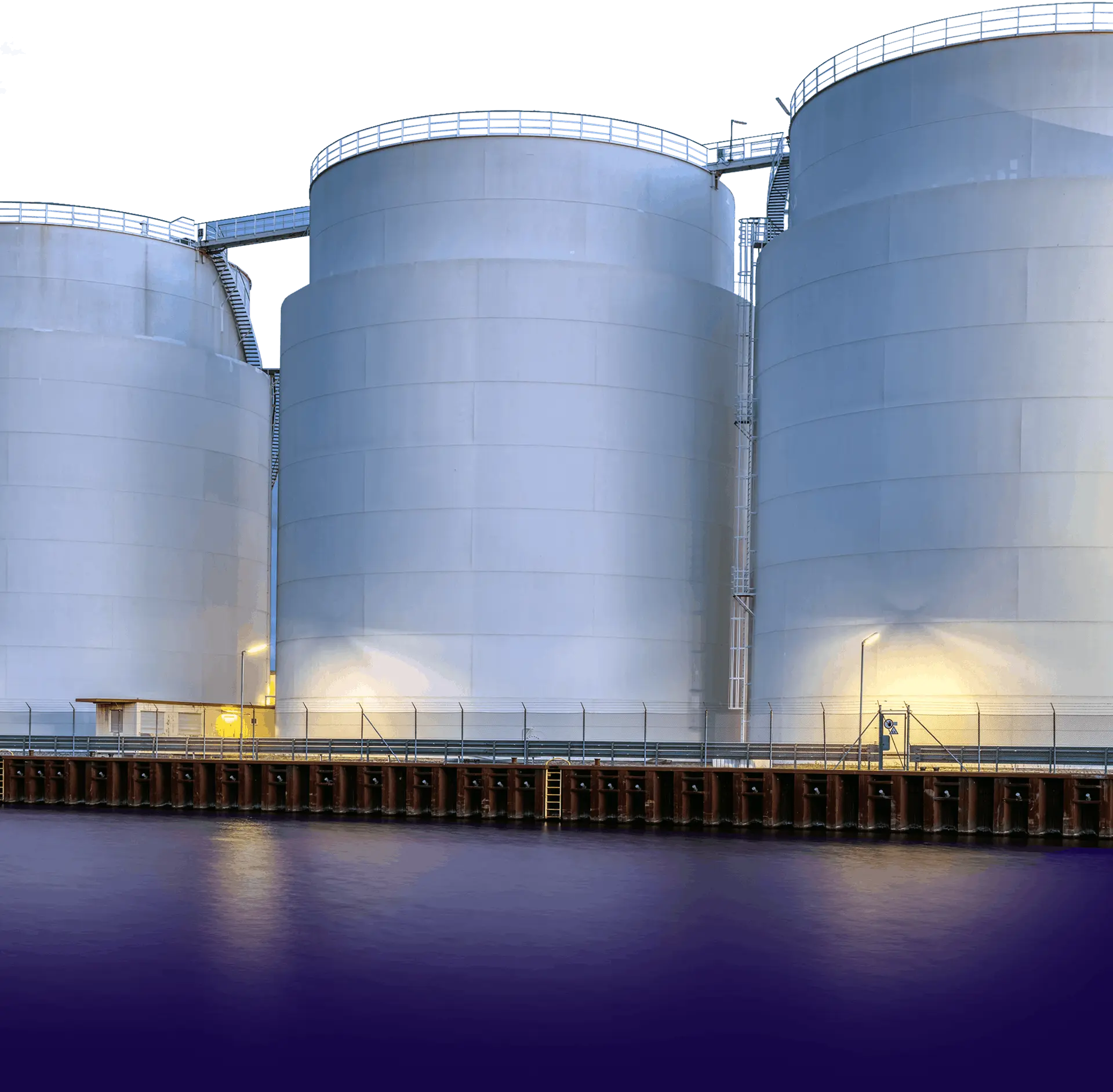 white silos along the water